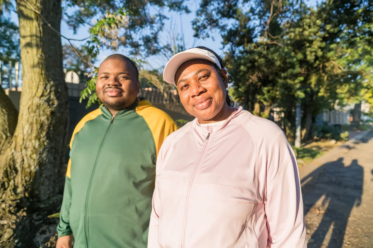 Madam O and a fellow walker standing together under a tree.